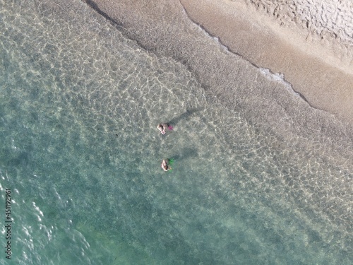 Fototapeta Naklejka Na Ścianę i Meble -  Aerial view of kanali beach crowded with tourists, famous tourist destination in preveza, epirus, greece