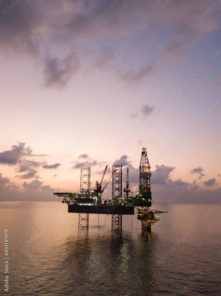 Offshore Jack Up Rig in The Middle of The Sea at Sunset Time for Petroluem Exploration and Production