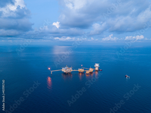 Central processing platform (cpp) in the middle of the ocean during sunset time - upstream industry.