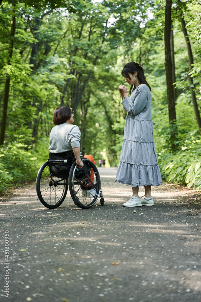 Girl with lower body disability spending time with her best friend at the forest