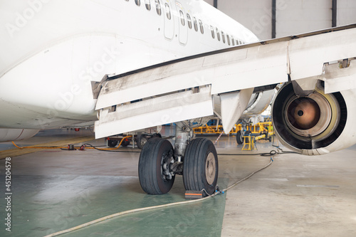 Close up shot of aircraft wheel, landing gear in airport hangar. Plane, shipping, transportation concept