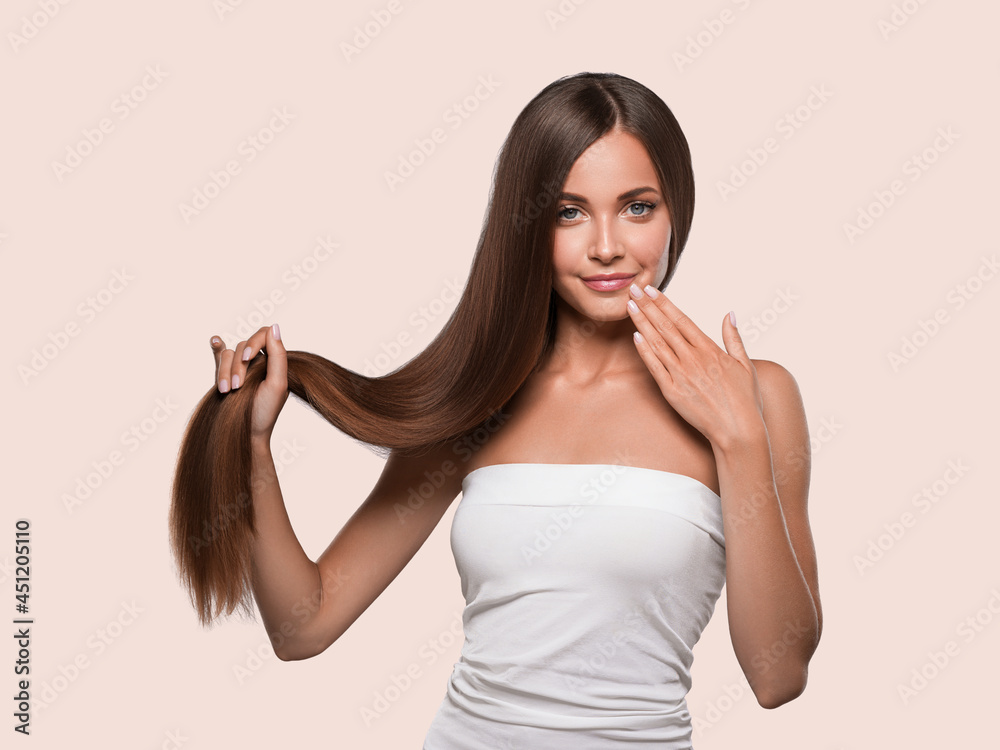 Woman with long smooth hair breunette natural make up healthy skin manicure nails Woman with long smooth hair breunette natural make up healthy skin manicure nails