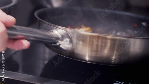 shrimp with hot peppers fried in a frying pan photo