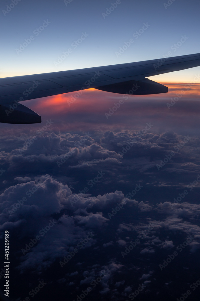 copy space window view of an airplane wing during a sunset with clouds copy space window view of an airplane wing during a sunset with clouds