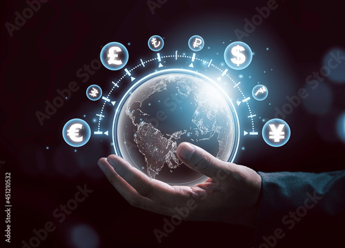 Global currency exchange concept, Businessman holding world with virtual line effect and dollar yuan yen euro and pound sterling sign.