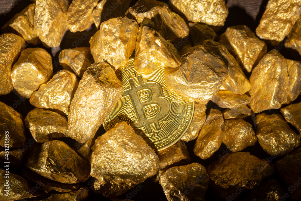 Close up of gold bullion and bitcoin, Concept of financial cryptocurrency Close up of gold bullion and bitcoin, Concept of financial cryptocurrency