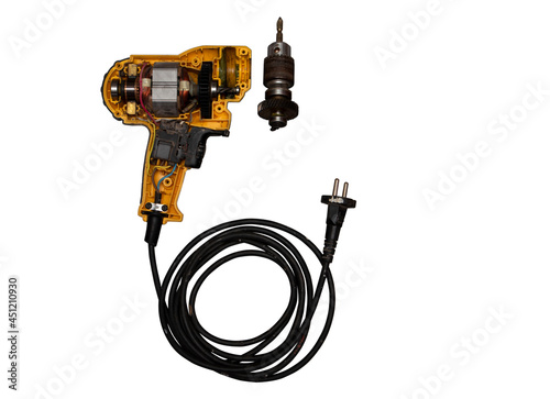 detachable used electric drill on white background The lid opens to reveal the internal components that include the motor, gear and switch.