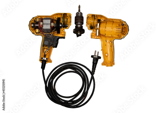 detachable used electric drill on white background The lid opens to reveal the internal components that include the motor, gear and switch.