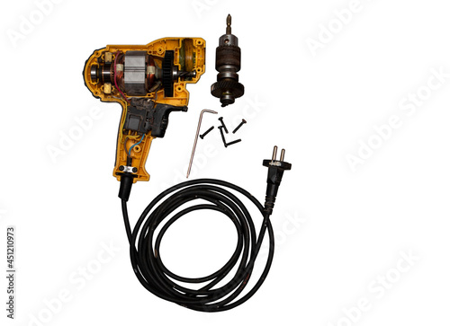 detachable used electric drill on white background The lid opens to reveal the internal components that include the motor, gear and switch.