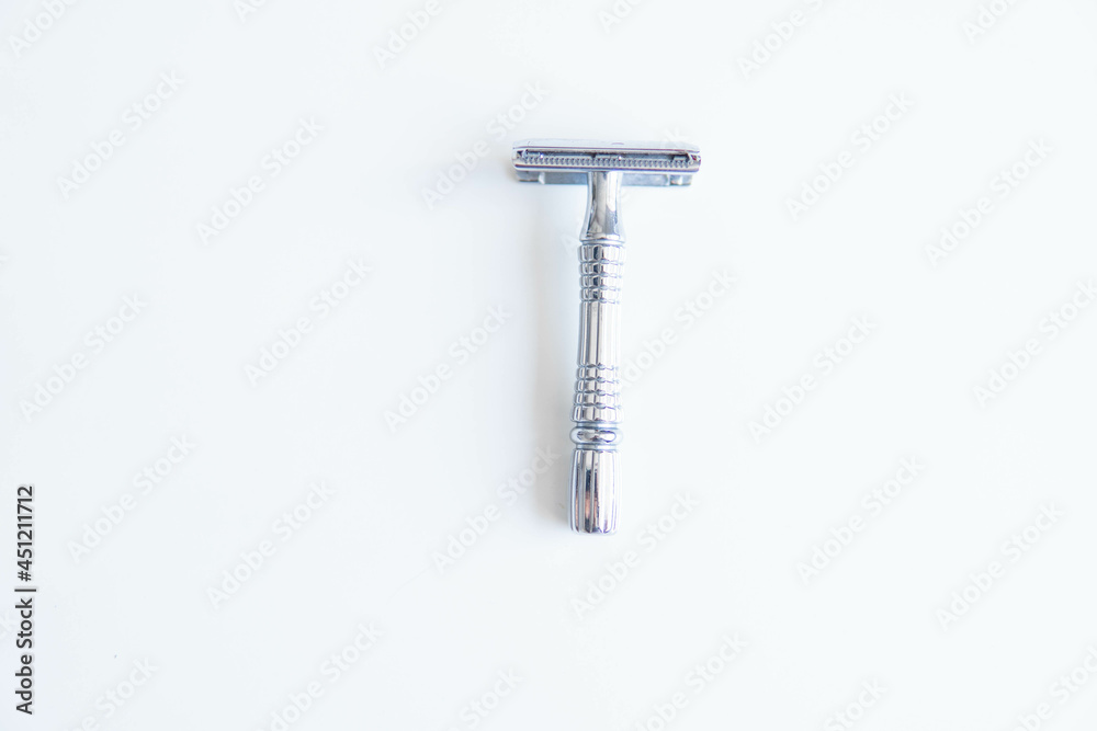 Vintage safety metal razor on a white background. Close-up. Isolated on white background. Reusable blade, zero waste product