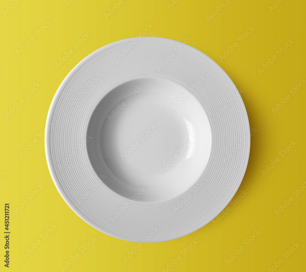 white ceramic plate on yellow white ceramic plate on yellow