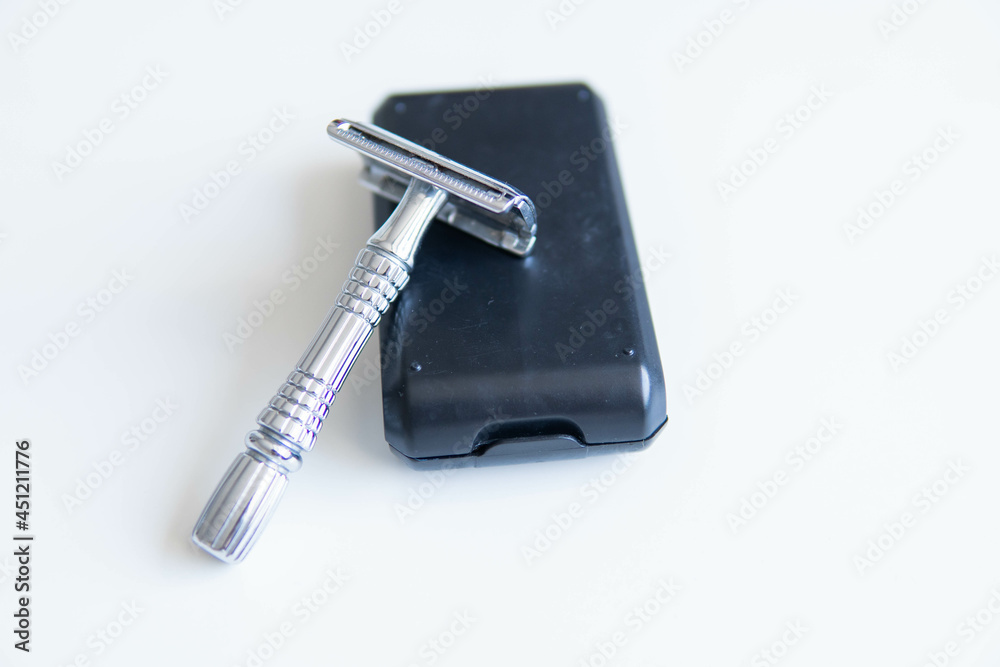 Vintage safety metal razor on a white background. Close-up. Isolated on white background. Reusable blade, zero waste product