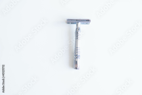Vintage safety metal razor on a white background. Close-up. Isolated on white background. Reusable blade, zero waste product 