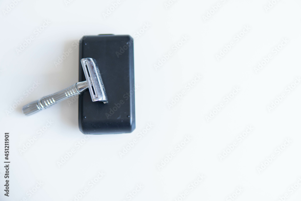 Vintage safety metal razor on a white background. Close-up. Isolated on white background. Reusable blade, zero waste product