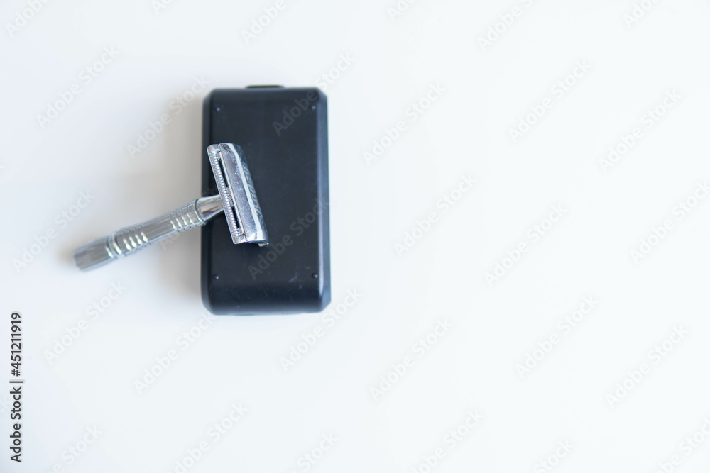 Vintage safety metal razor on a white background. Close-up. Isolated on white background. Reusable blade, zero waste product