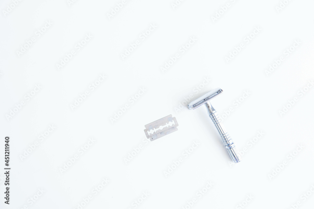 Vintage safety metal razor on a white background. Close-up. Isolated on white background. Reusable blade, zero waste product