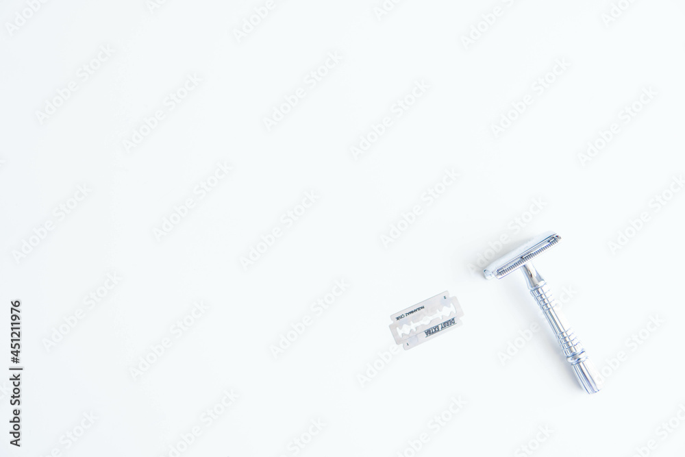Vintage safety metal razor on a white background. Close-up. Isolated on white background. Reusable blade, zero waste product