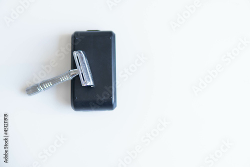 Vintage safety metal razor on a white background. Close-up. Isolated on white background. Reusable blade, zero waste product

