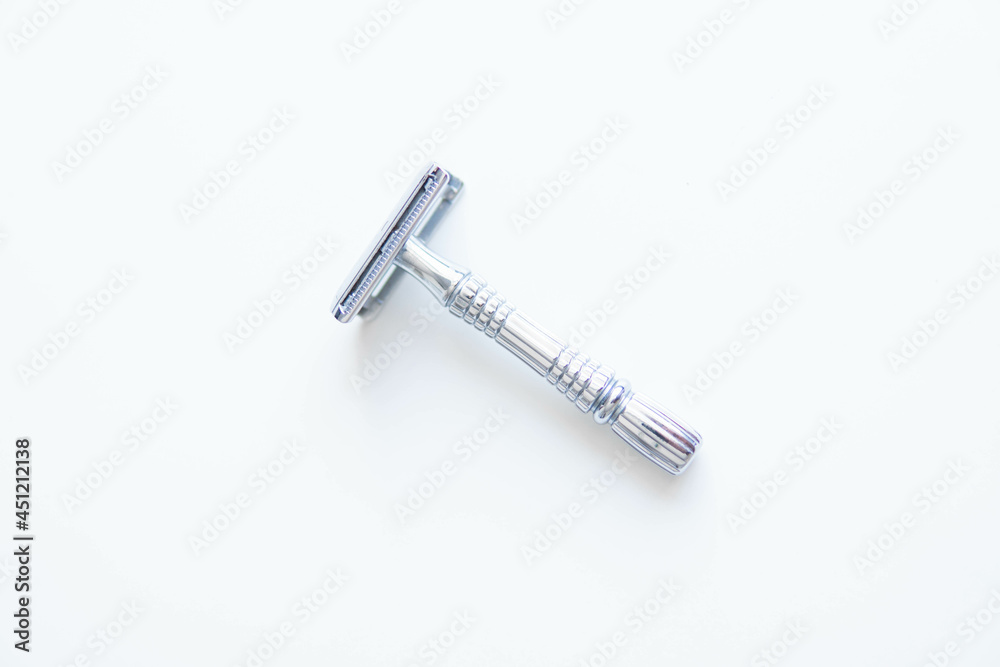 Vintage safety metal razor on a white background. Close-up. Isolated on white background. Reusable blade, zero waste product
