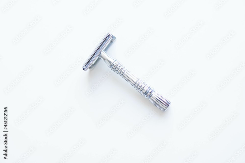 Vintage safety metal razor on a white background. Close-up. Isolated on white background. Reusable blade, zero waste product

