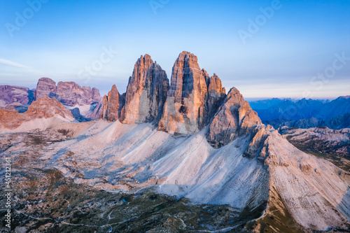 Aerial view of Tre Cime di Lavaredo pinked colored during sunset. Dolomites, Italy