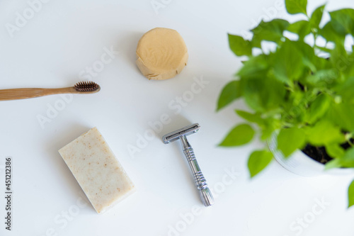 Obraz na płótnie Zero waste product, close up caption. Bamboo toothbrush, solid shampoo, metal razor and solid hand soap. Sustainable bathroom products on a white background. w salonie
