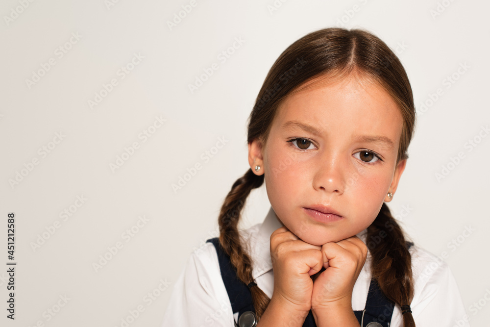 portrait of pensive schoolkid with hands near chin isolated on grey portrait of pensive schoolkid with hands near chin isolated on grey