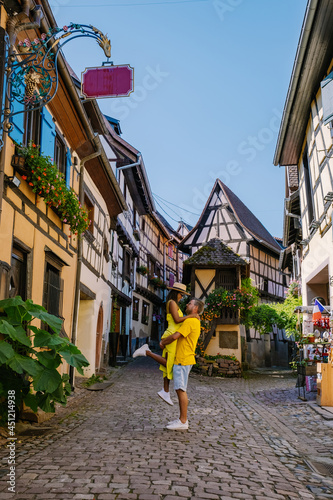 Eguisheim, Alsace, France, Traditional colorful halt-timbered houses in Eguisheim Old Town on Alsace Wine Route, France.colorful streets old town, couple man and woman on vacation inf France Elzas photo