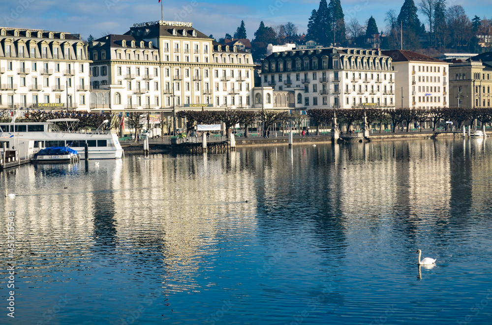 View of downtown Lucerne in Switzerland with the reflection of the building in the lake with a swan