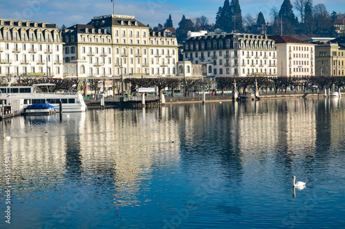 View of downtown Lucerne in Switzerland with the reflection of the building in the lake with a swan