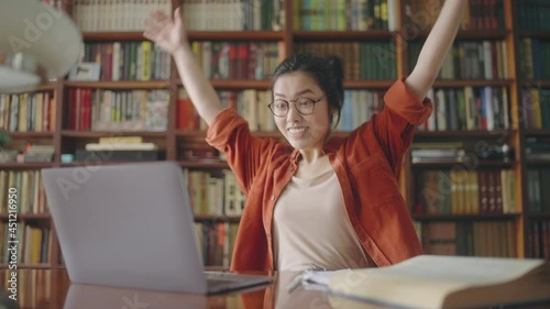 Happy asian woman excited after receiving great news, accepted into university
