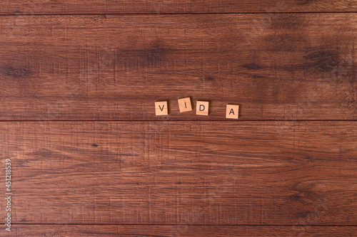 Frases motivadoras con letras naturales sobre una mesa o suelo de madera rustica.