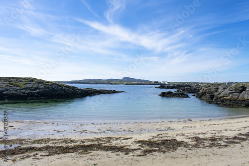 Treaddur Bay, Anglesey, Wales. Beautiful seascape of a rocky small cove, with a secluded beach. Charming summer scene. Blue sky and copy space. © John