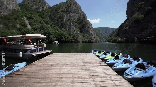 Landscape view of a green metal boat on colourful water Canyon Matka, north Macedonia photo