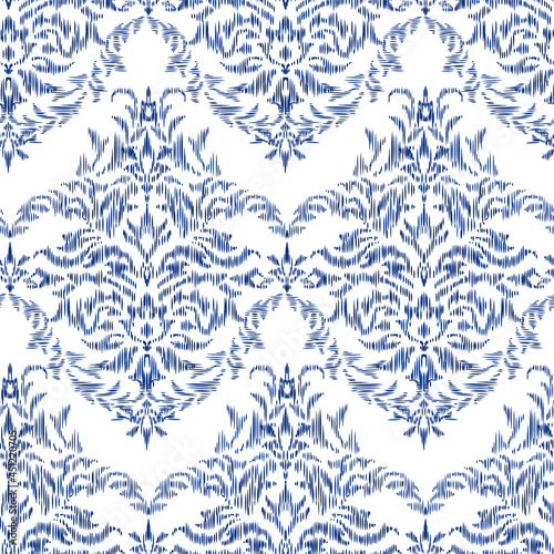 Seamless pattern - Tribal Art Ikat in traditional classic blue and white colors. Damascus - in Syrian Flower Pattern. Boho style. Printing on fabric. Ornamental plant pattern imitating weaving embroid