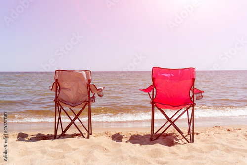 folding chairs on the sea sandy beach. camping. sunny.