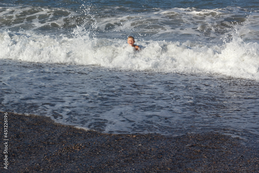 Boy in the sea waves