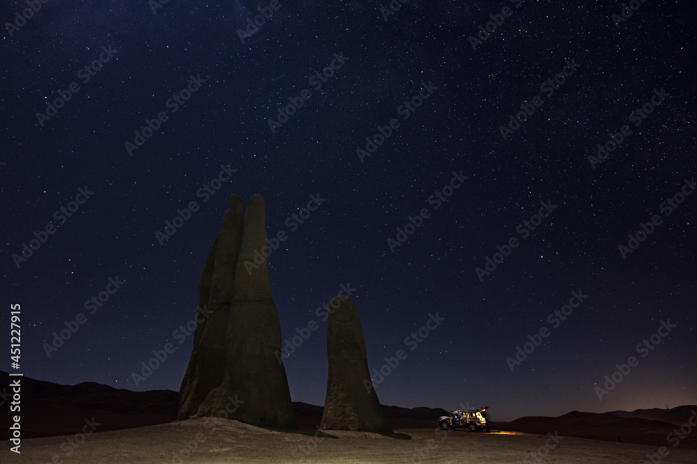 Chilean hand of the desert with a truck aside in a night full of stars in Antofagasta, Chile Chilean hand of the desert with a truck aside in a night full of stars in Antofagasta, Chile