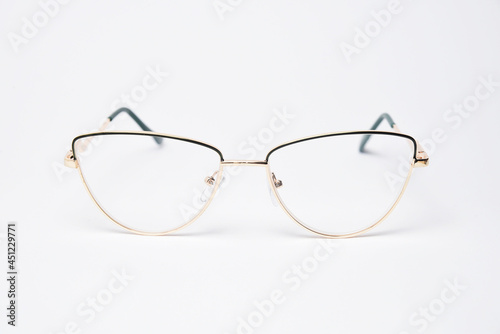 Golden stylish metal glasses front view. Eyewear modern diopter glasses