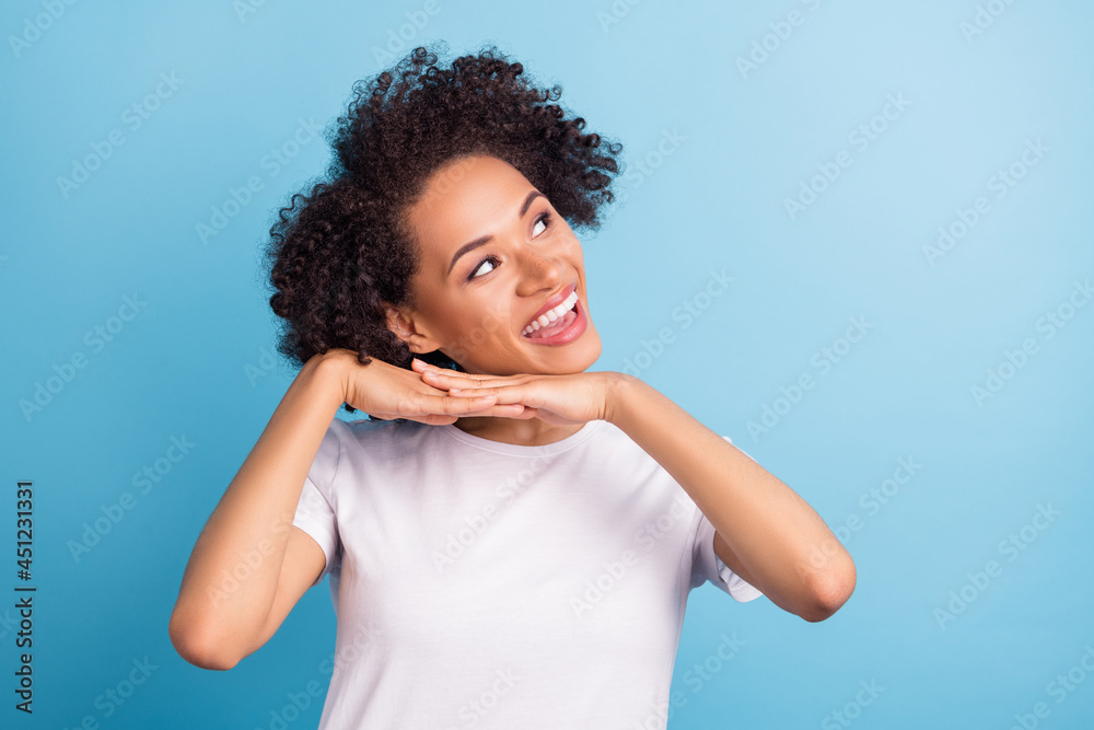 Photo of young smiling gorgeous cheerful afro girl look copyspace dreaming isolated on blue color background Photo of young smiling gorgeous cheerful afro girl look copyspace dreaming isolated on blue color background