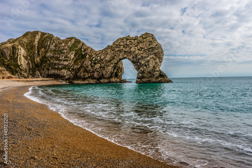 The Famous Durdle Door Stone Arch in Dorset on the English Coast  photo