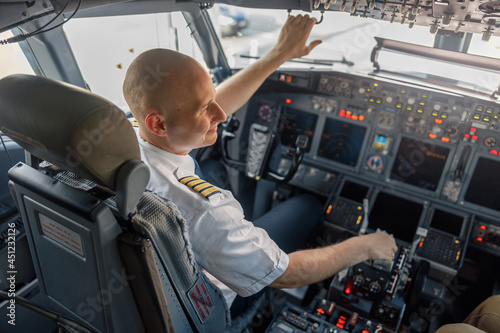 Konstfotografi High angle view of professional pilot sitting in an airplane cabin, ready for takeoff
