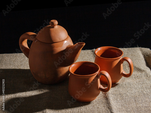 still life with a clay teapot and two cups