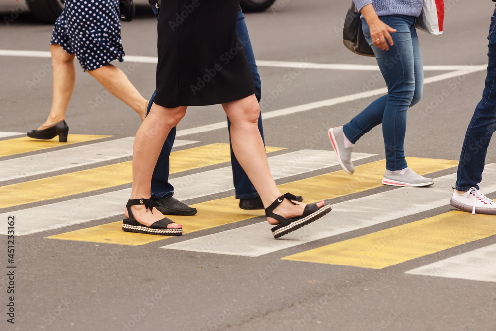 pedestrians walking on a crosswalk pedestrians walking on a crosswalk