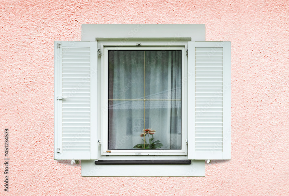 Windows with white shutters on light pink facade