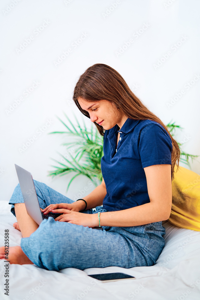 Happy woman working on laptop at home Happy woman working on laptop at home