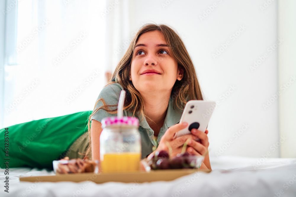 Young woman using smartphone during breakfast Young woman using smartphone during breakfast