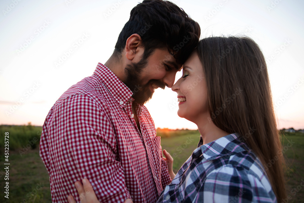 Embracing couple in rays of setting sun Embracing couple in rays of setting sun