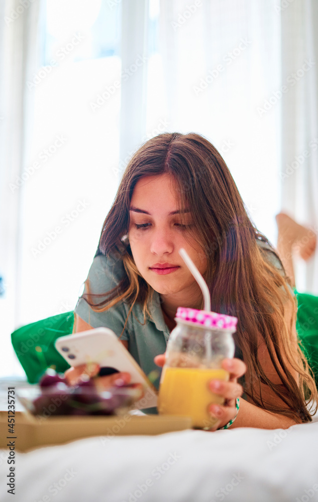 Young woman using smartphone during breakfast Young woman using smartphone during breakfast
