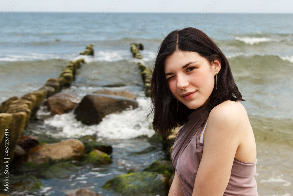 portrait of a young beautiful woman by the sea